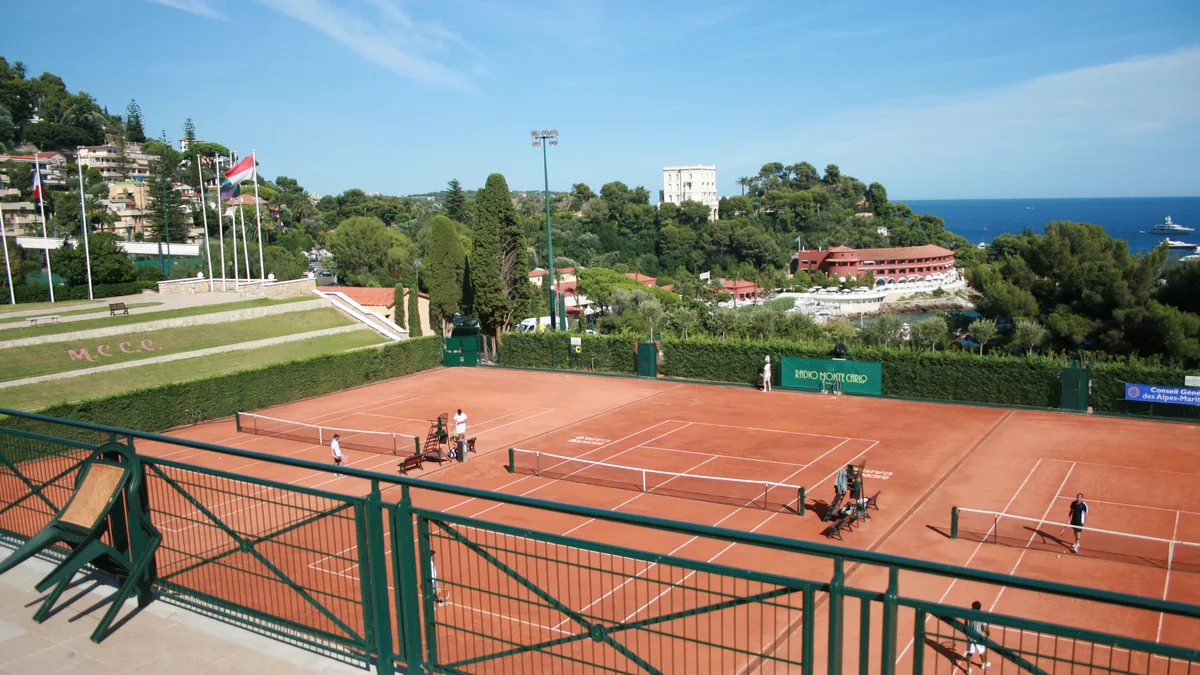 The clay courts of the Monte-Carlo Country Club, terraced above the Mediterranean Sea and the hills of Monaco